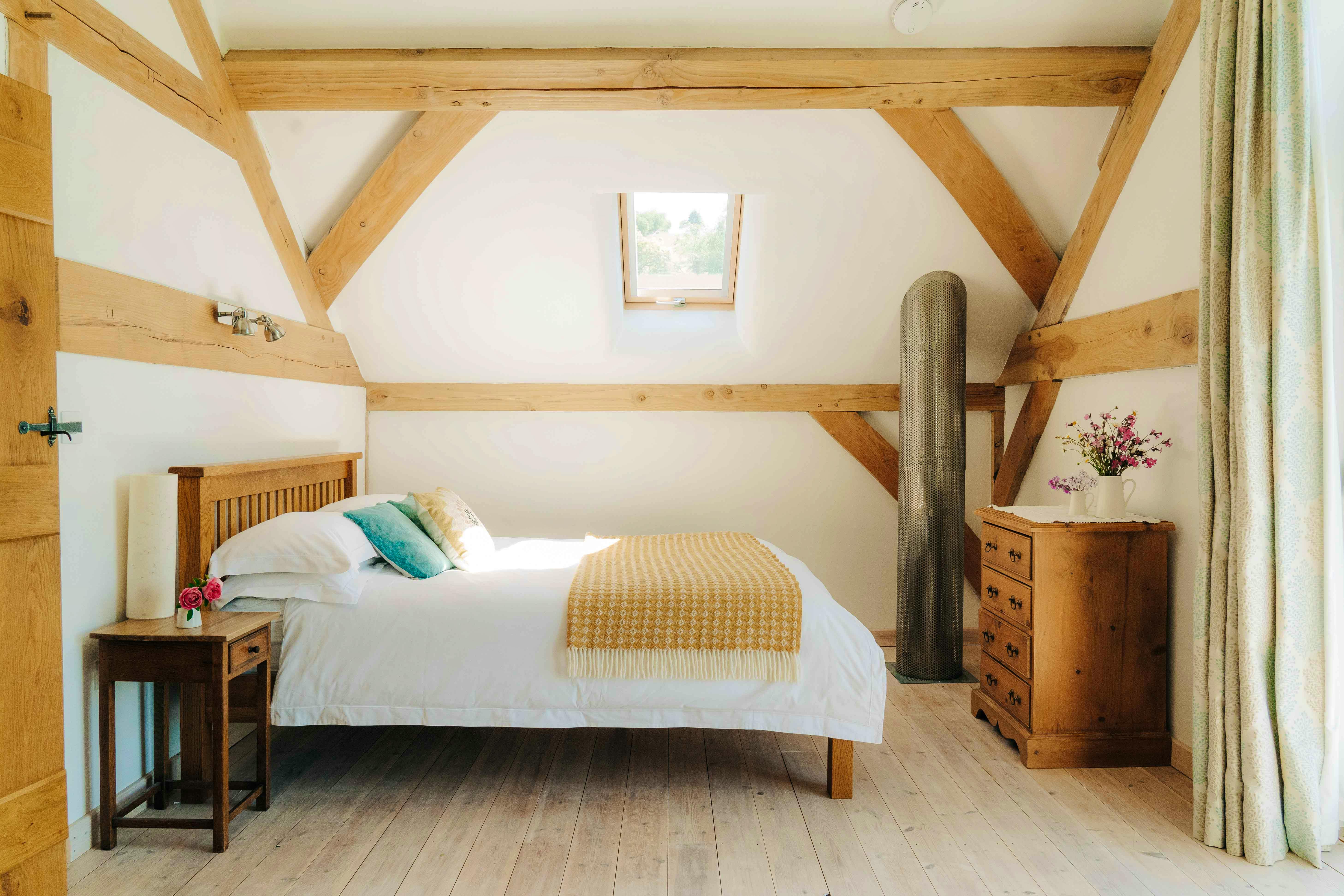 upstairs bedroom with lounge area and balcony 