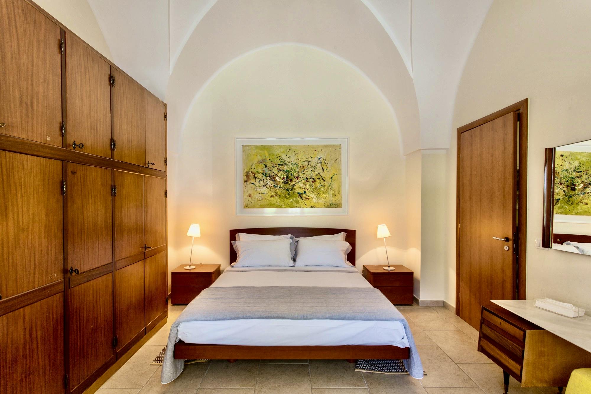 Master bedroom with original star-shaped ceilings and local artwork