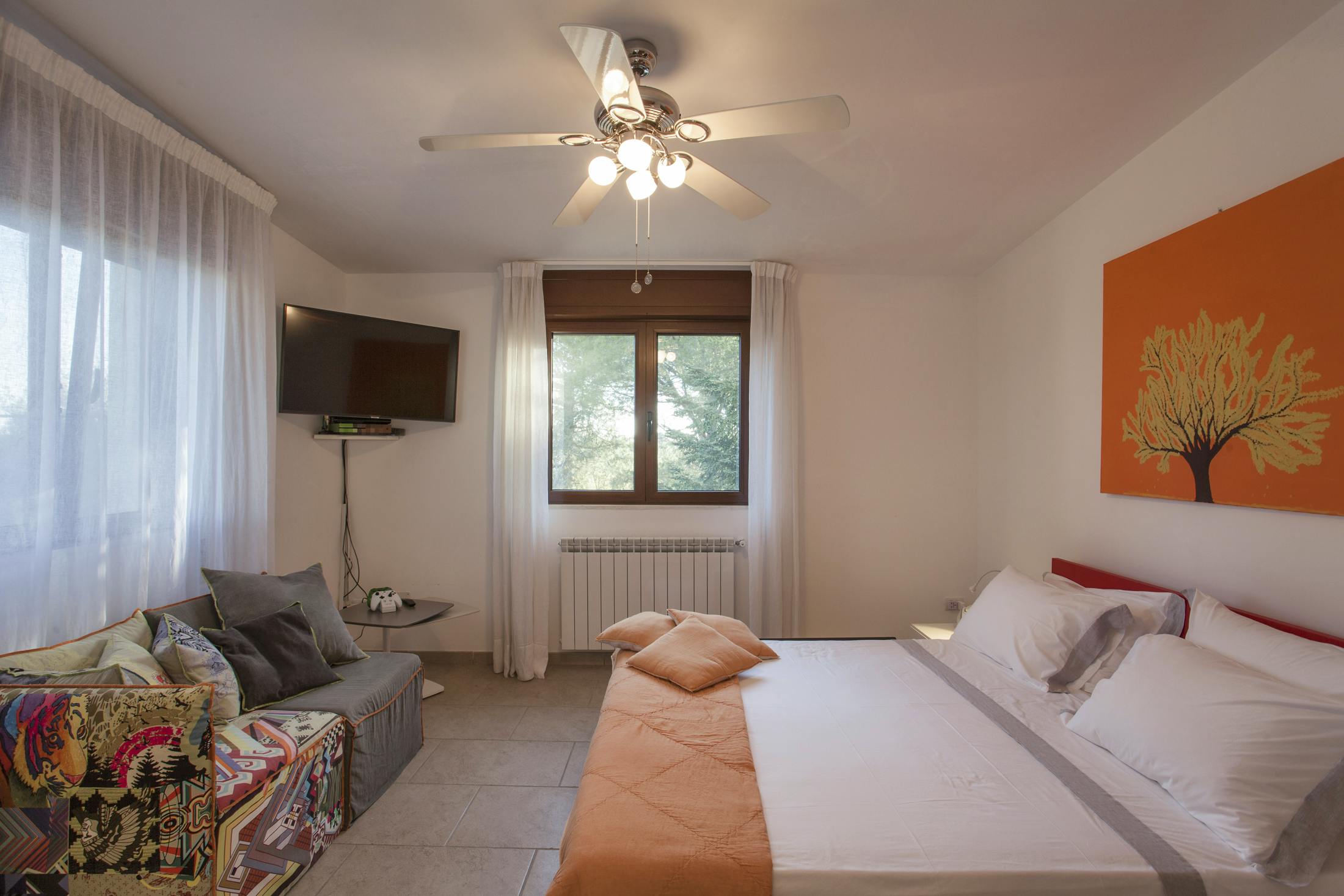 Master bedroom with designer furniture and flat screen TV