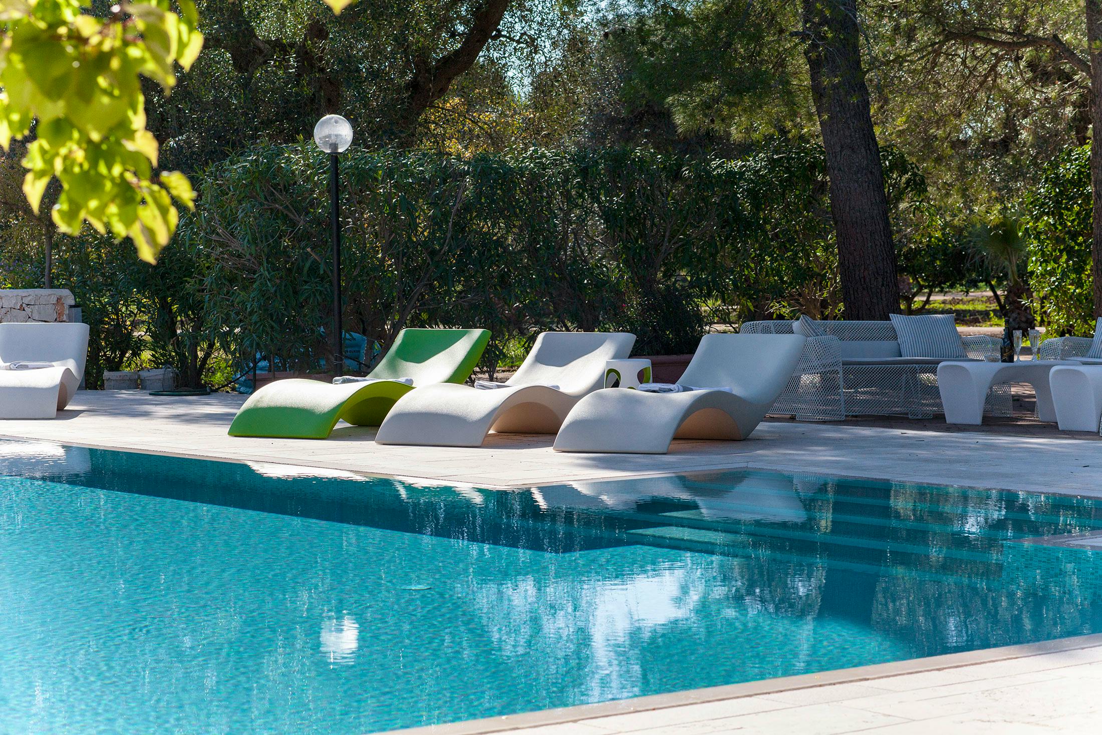 Pool solarium, designer loungers and large pool steps