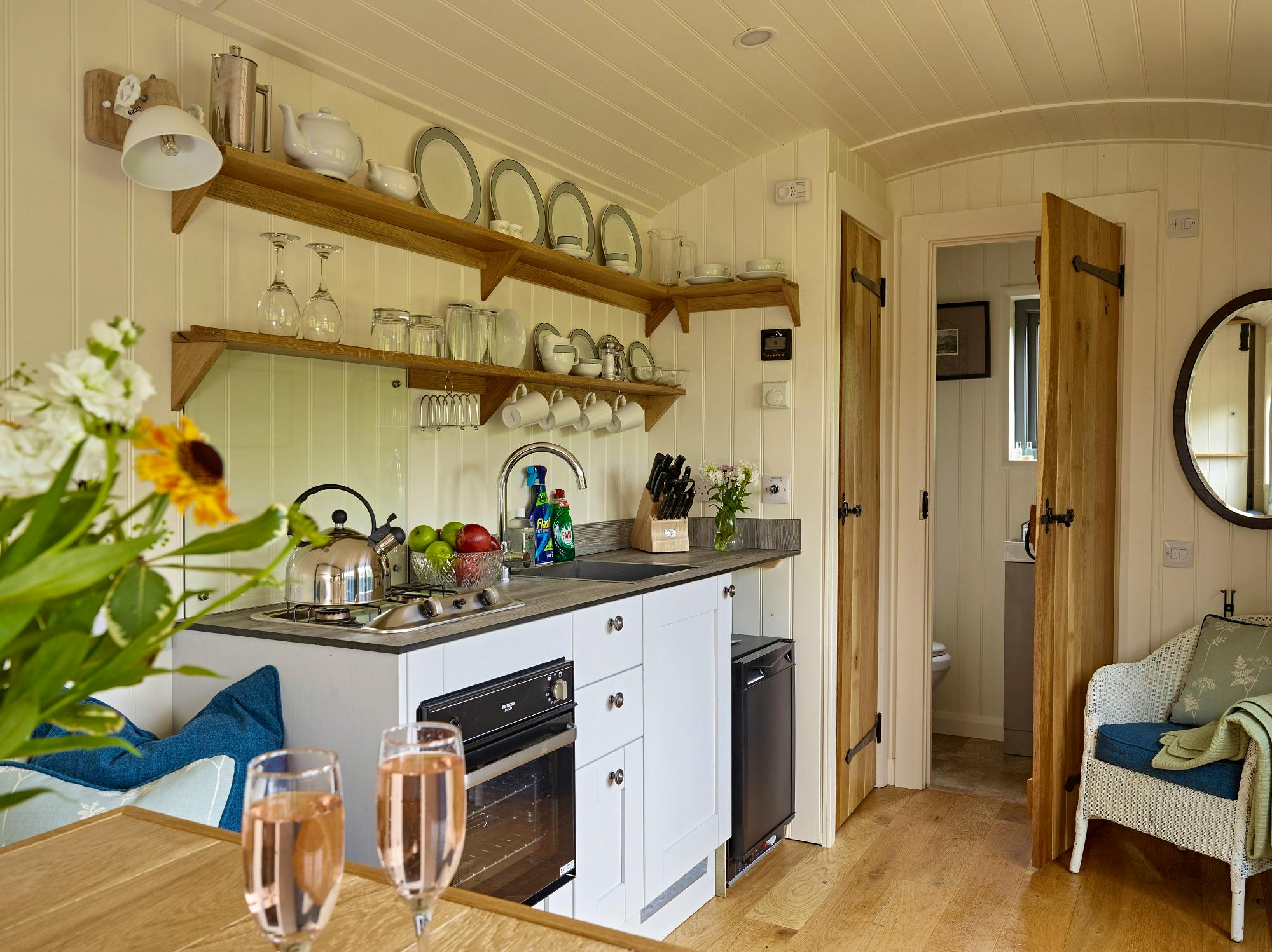 Elm Retreat kitchen with LPG hob, oven and fridge ensuite with shower room with LPG heating, hot water and solar power