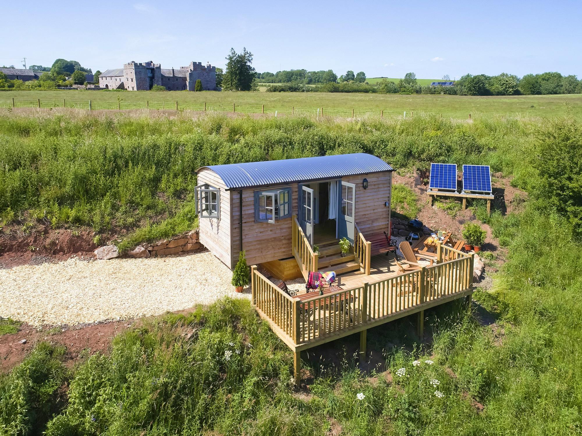 Hawthorn Retreat shepherds hut set in the grounds of Blencowe Hall private balcony overlooking river valley LPG heating