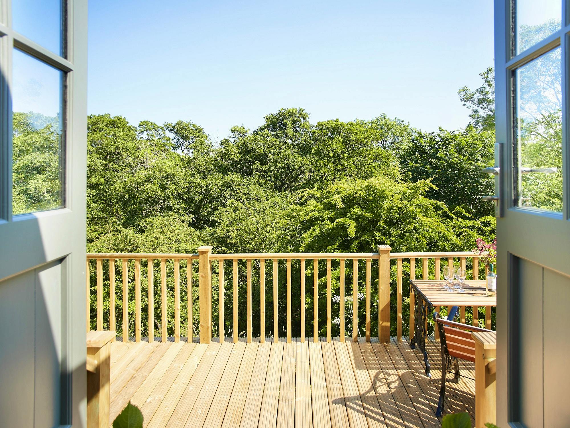Hawthorn Retreat private wooden balcony overlooking woodland valley of The River Petteril near Lake District National Park