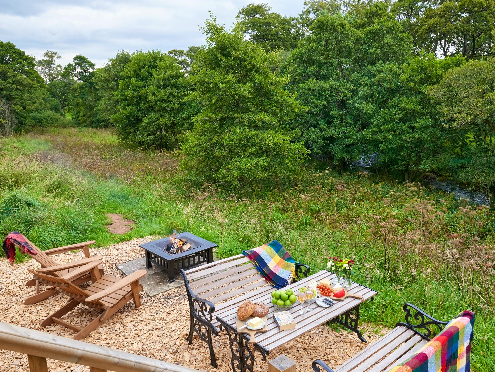 Rowan Retreat view over private riverfront meadow overlooking point with fire pit and outdoor table