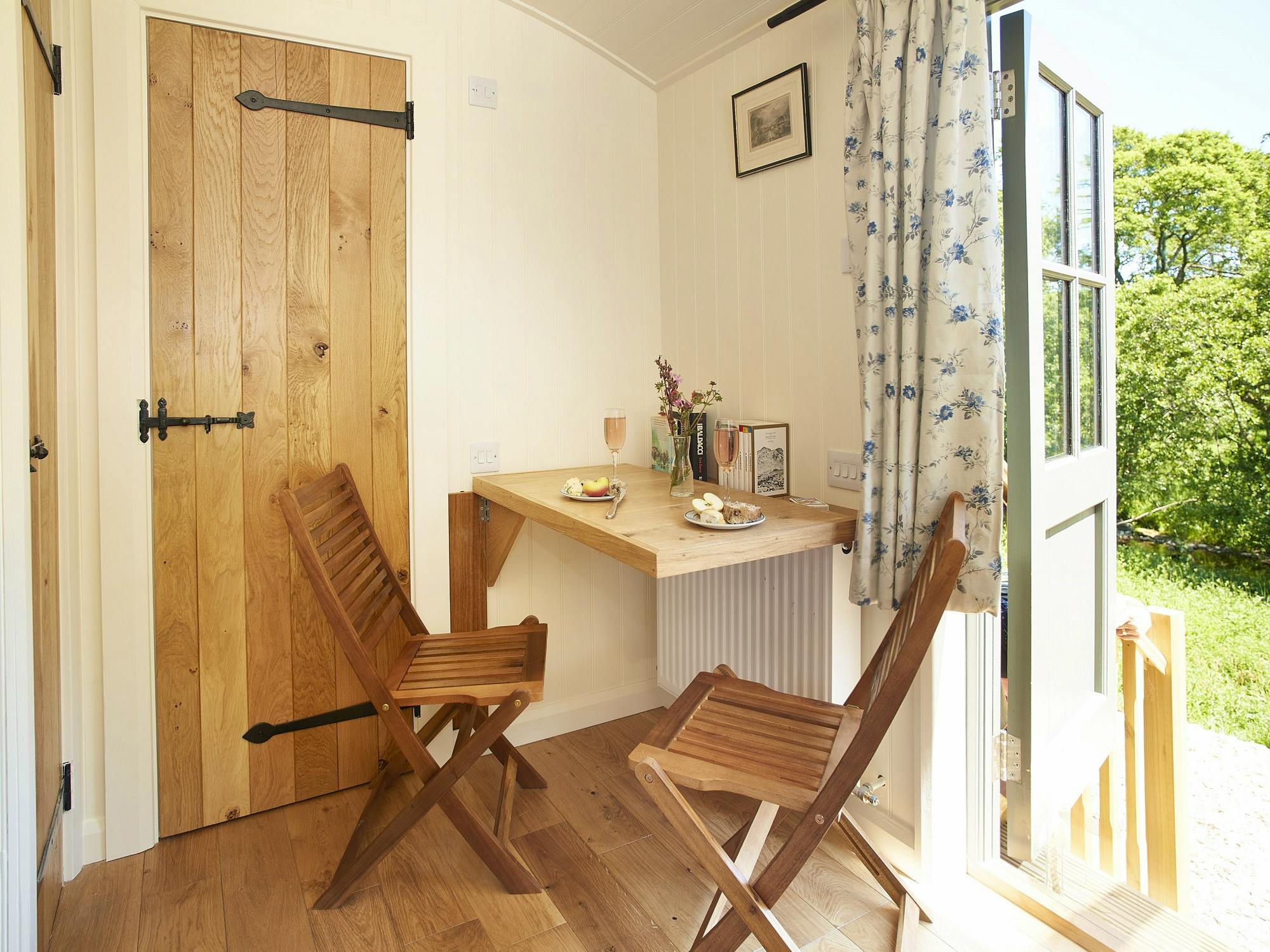 Rowan Retreat view from front door with handmade oak breakfasting table set up.  LPG heating