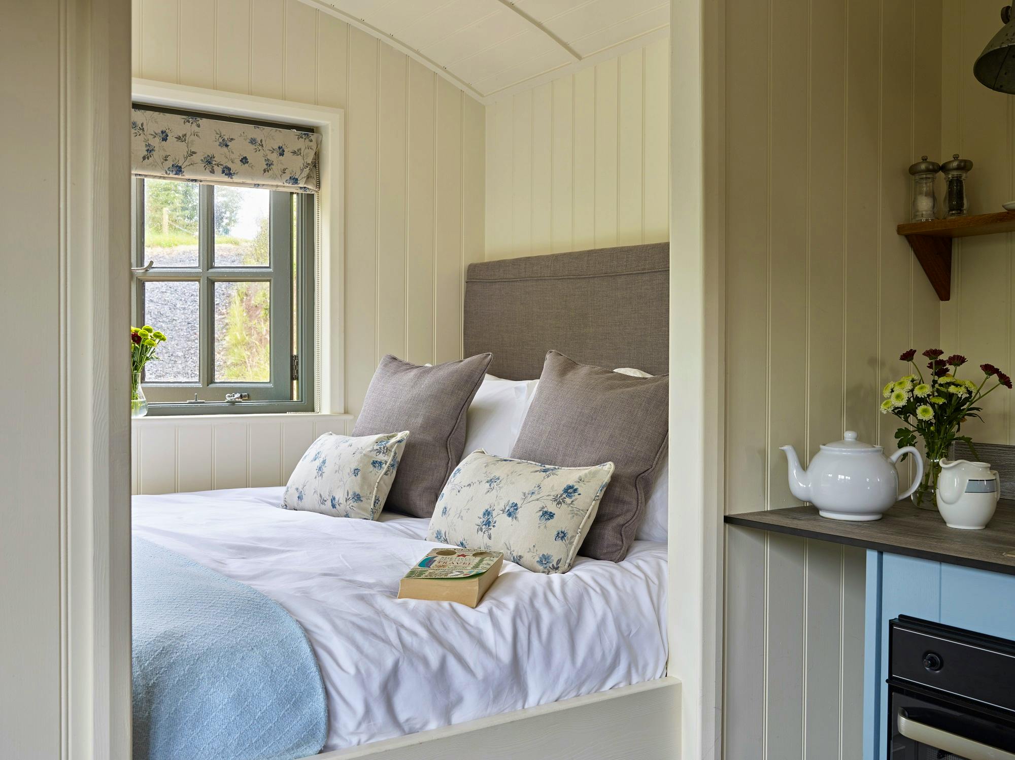 Rowan Retreat ensuite shepherds hut with five foot king size cozy cabin bed overlooking river valley