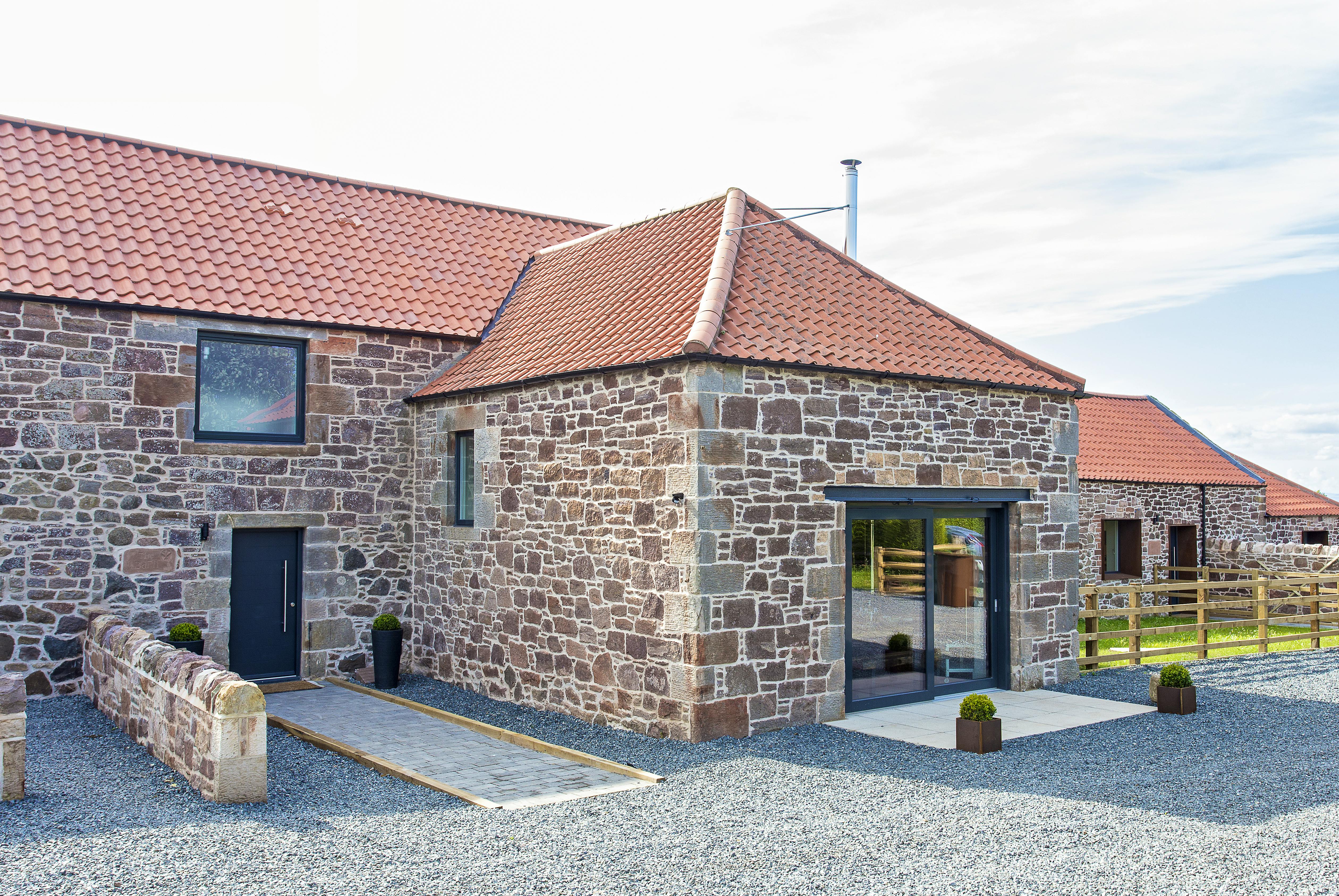View of the front of 'The Barn' with private parking for up to 6 cars
