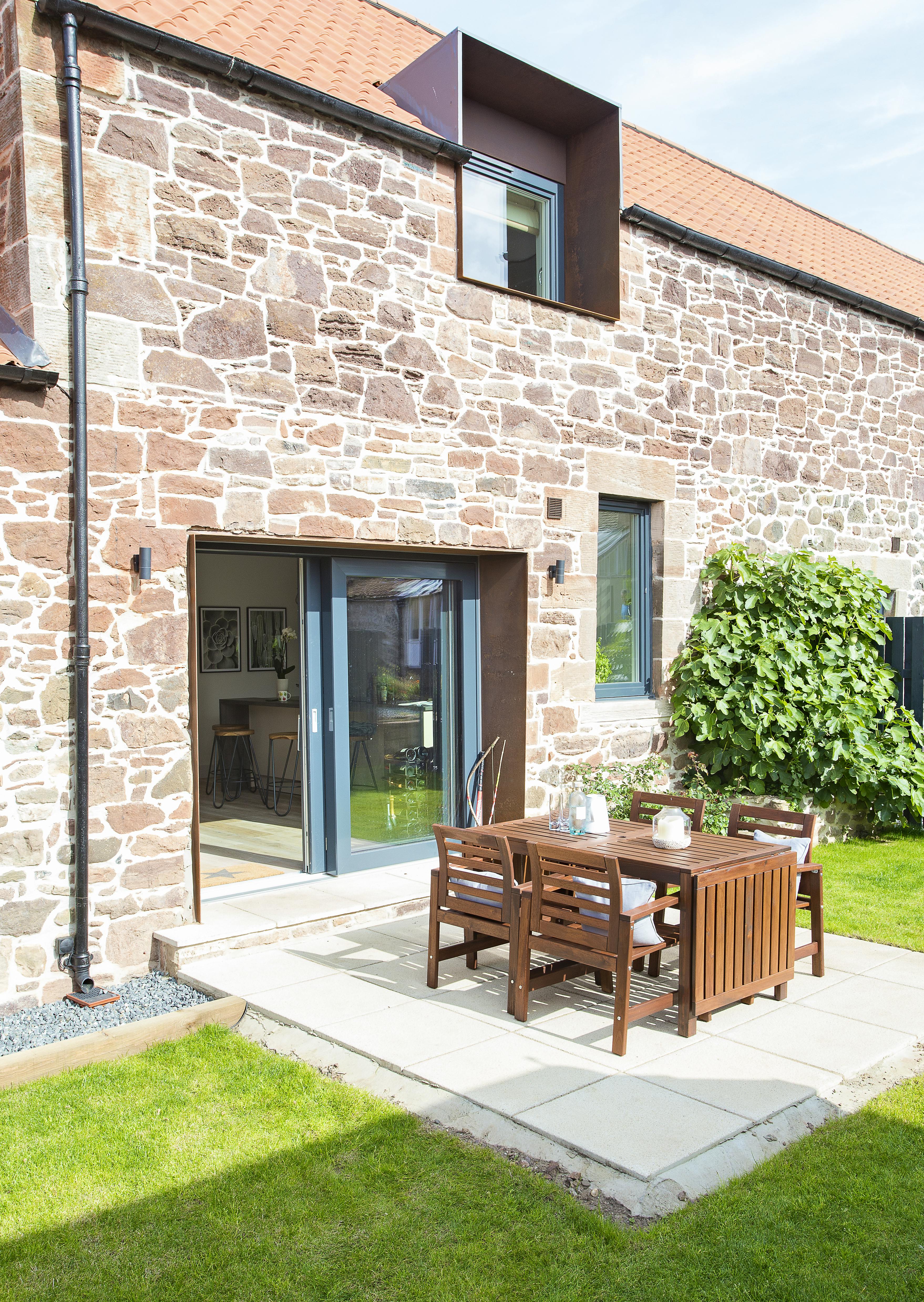 Secure back garden with outside dining table and chairs