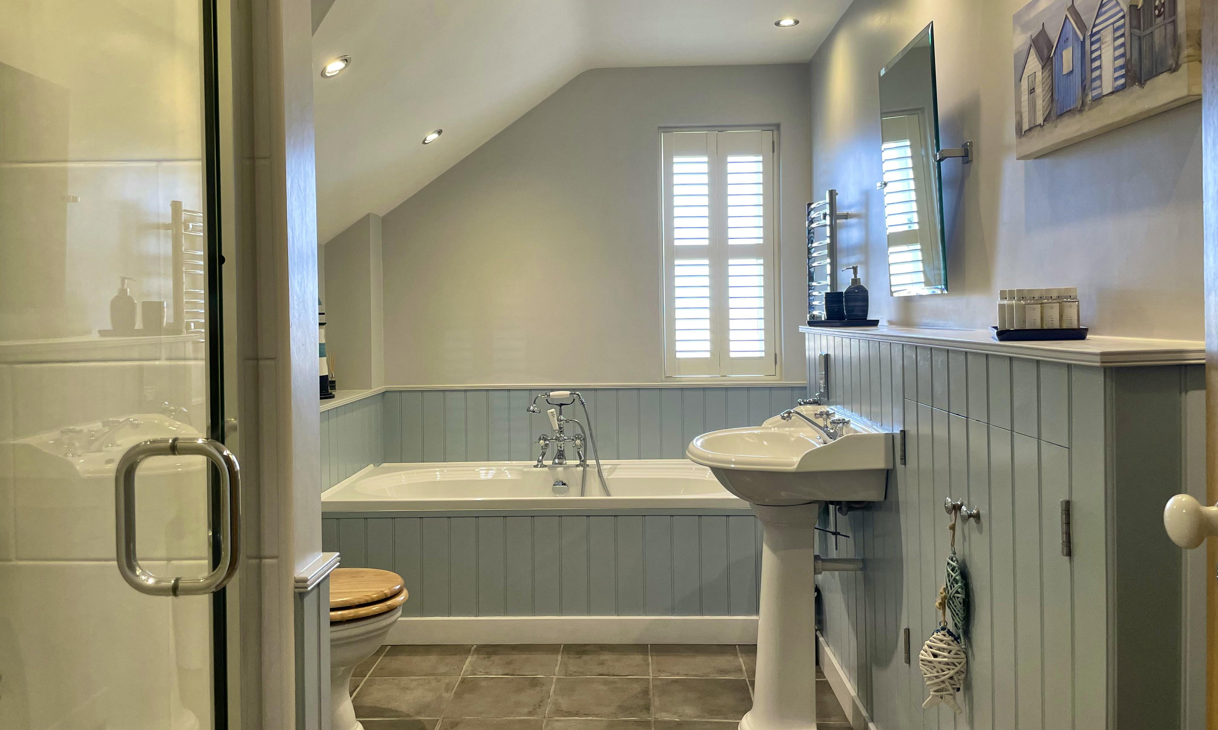 The spacious family Bathroom in Waterford has a relaxing coastal vibe