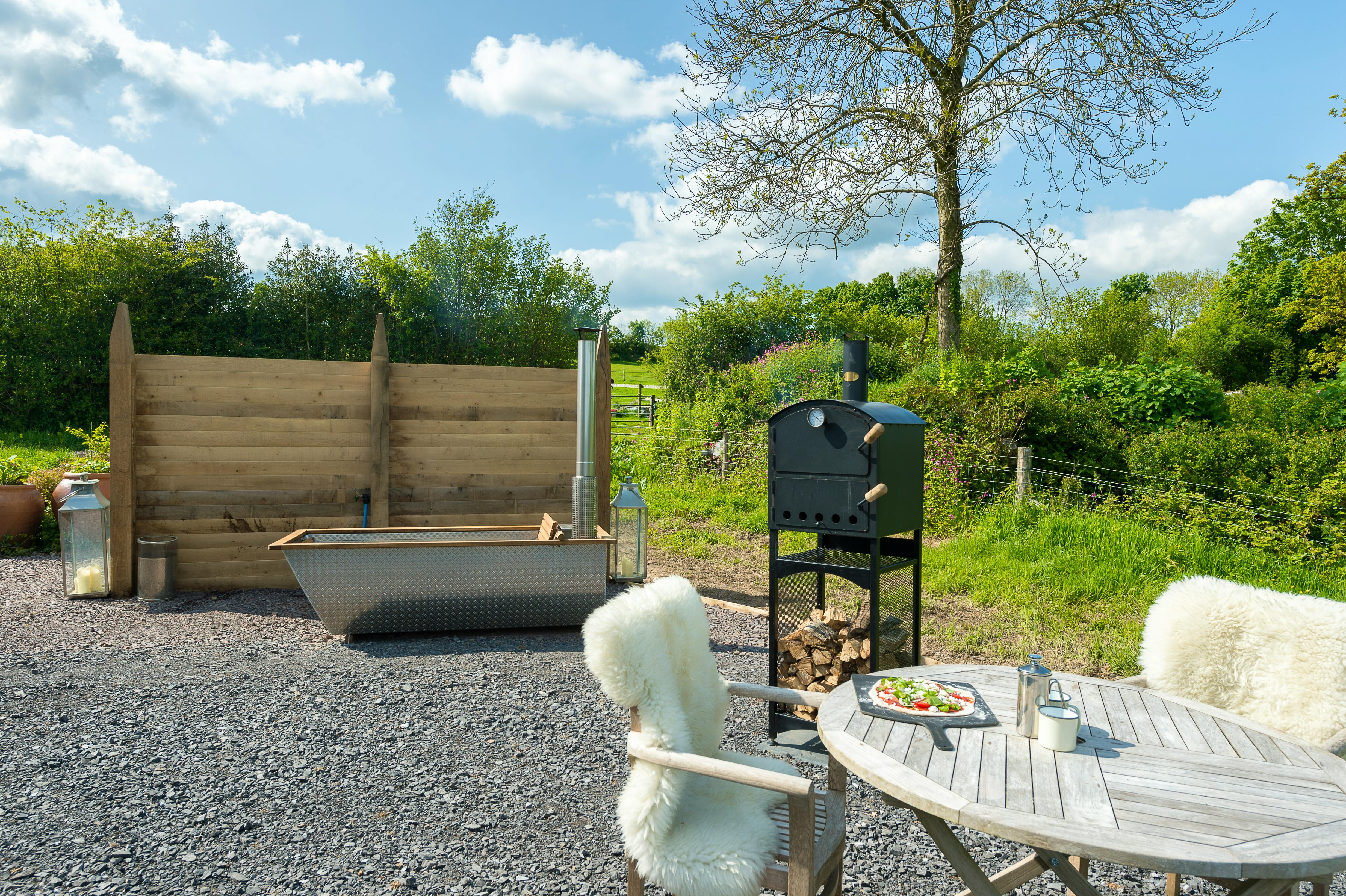 Your own private lounging and cooking area right outside the shepherd's hut - luxuriate in the wood-fired hot-tub whilst your supper is cooking...