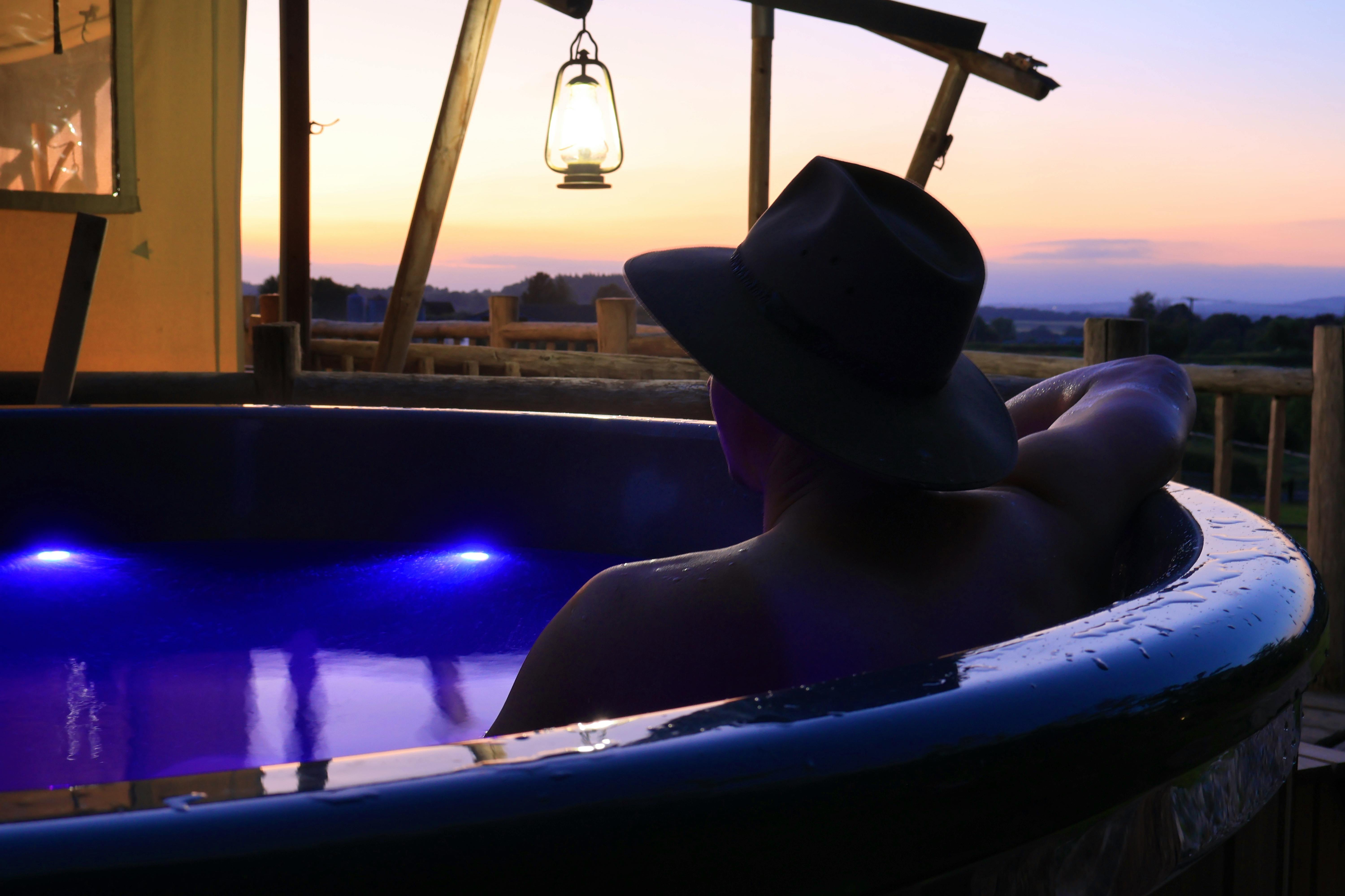 Cowboy in a Lodge Hot Tub at Dusk