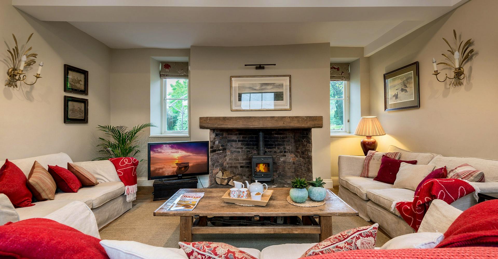 TV room with sofas and woodburner