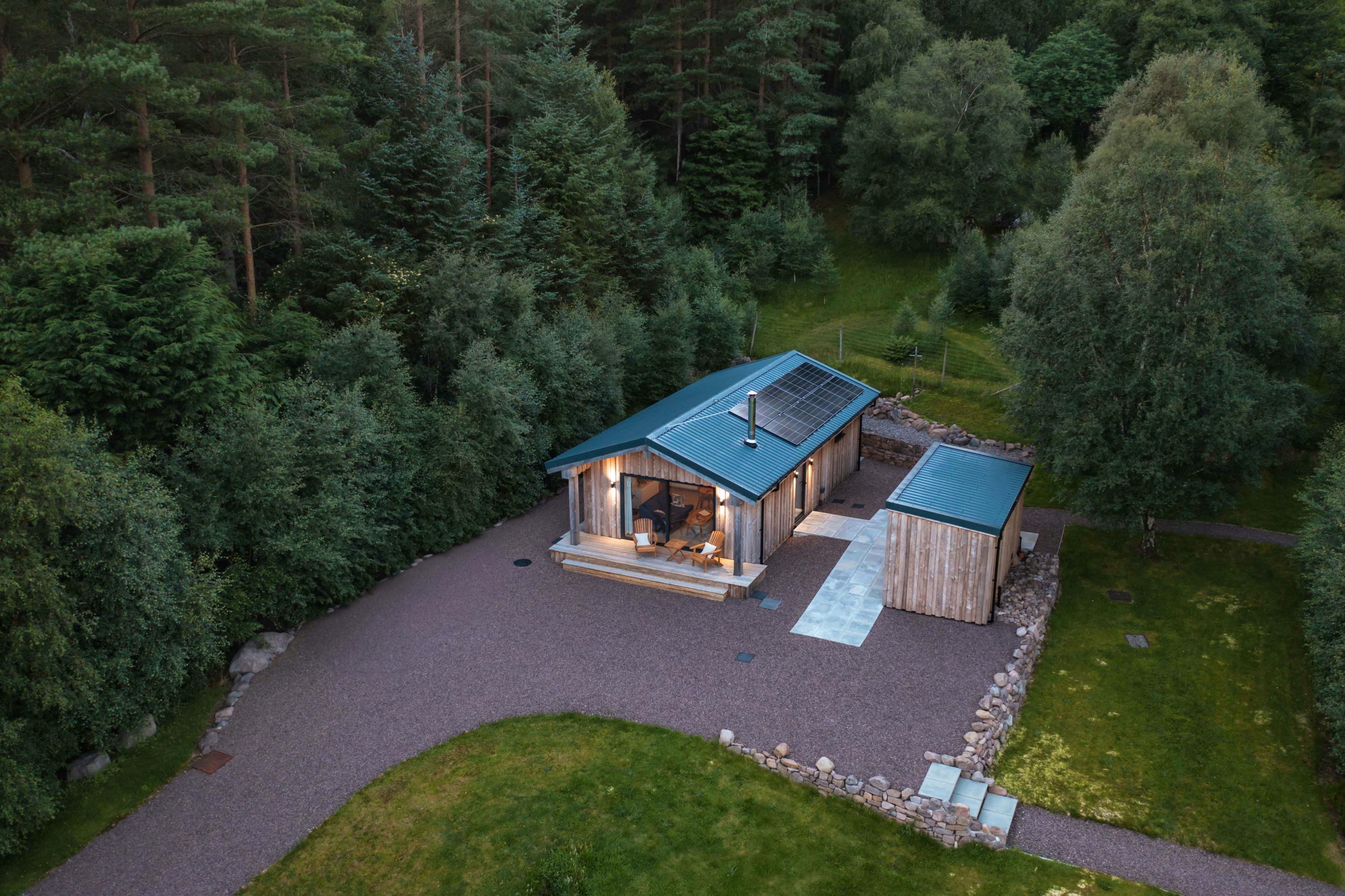 Cabin at dusk with outside lighting