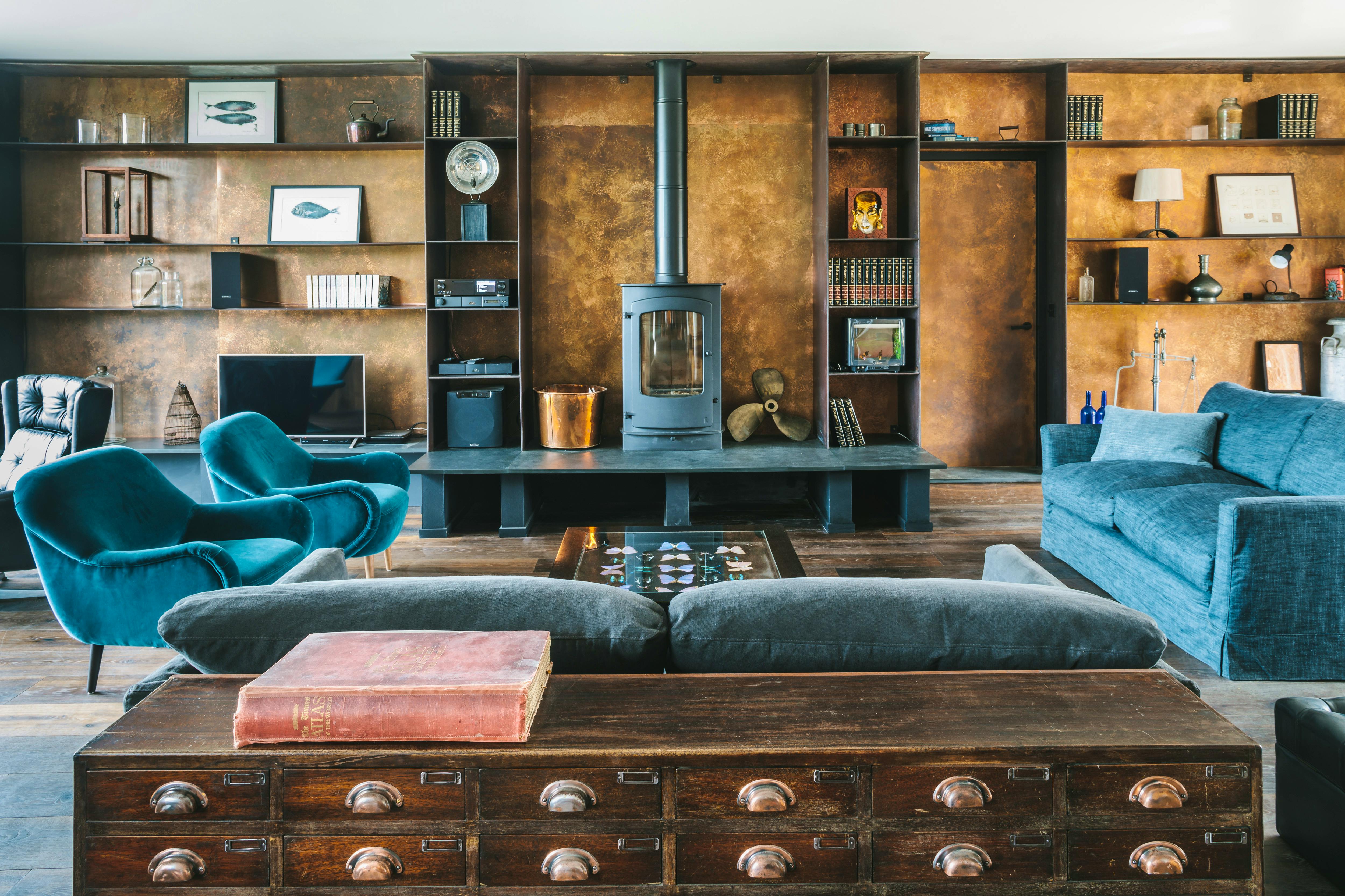 Copper clad walls and bespoke metal shelving make it feel cosy all year round