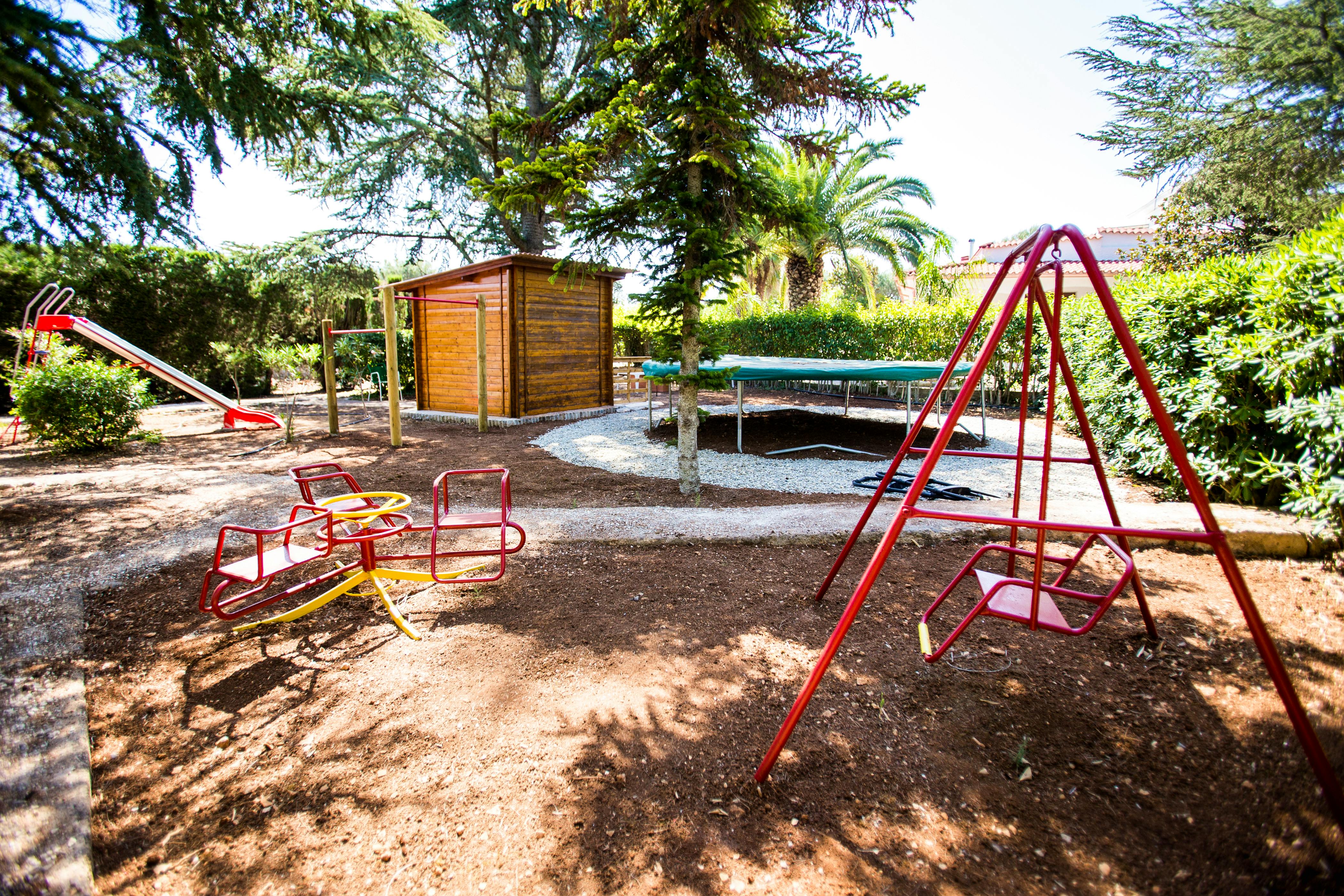 High quality playground equipment with gymnastics bars and large BERG trampoline.