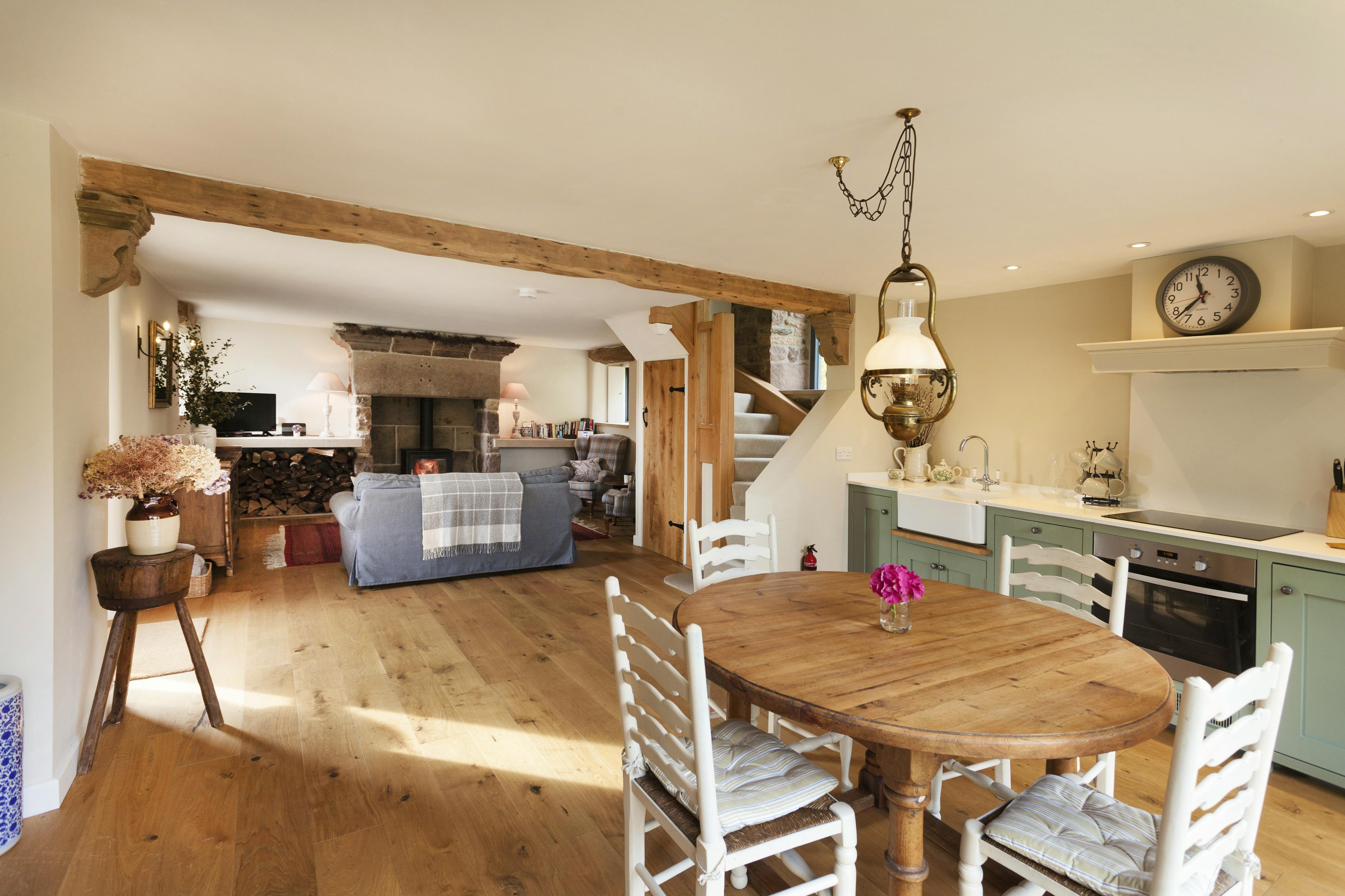 Open plan living area downstairs with underfloor heating and wood burning stove