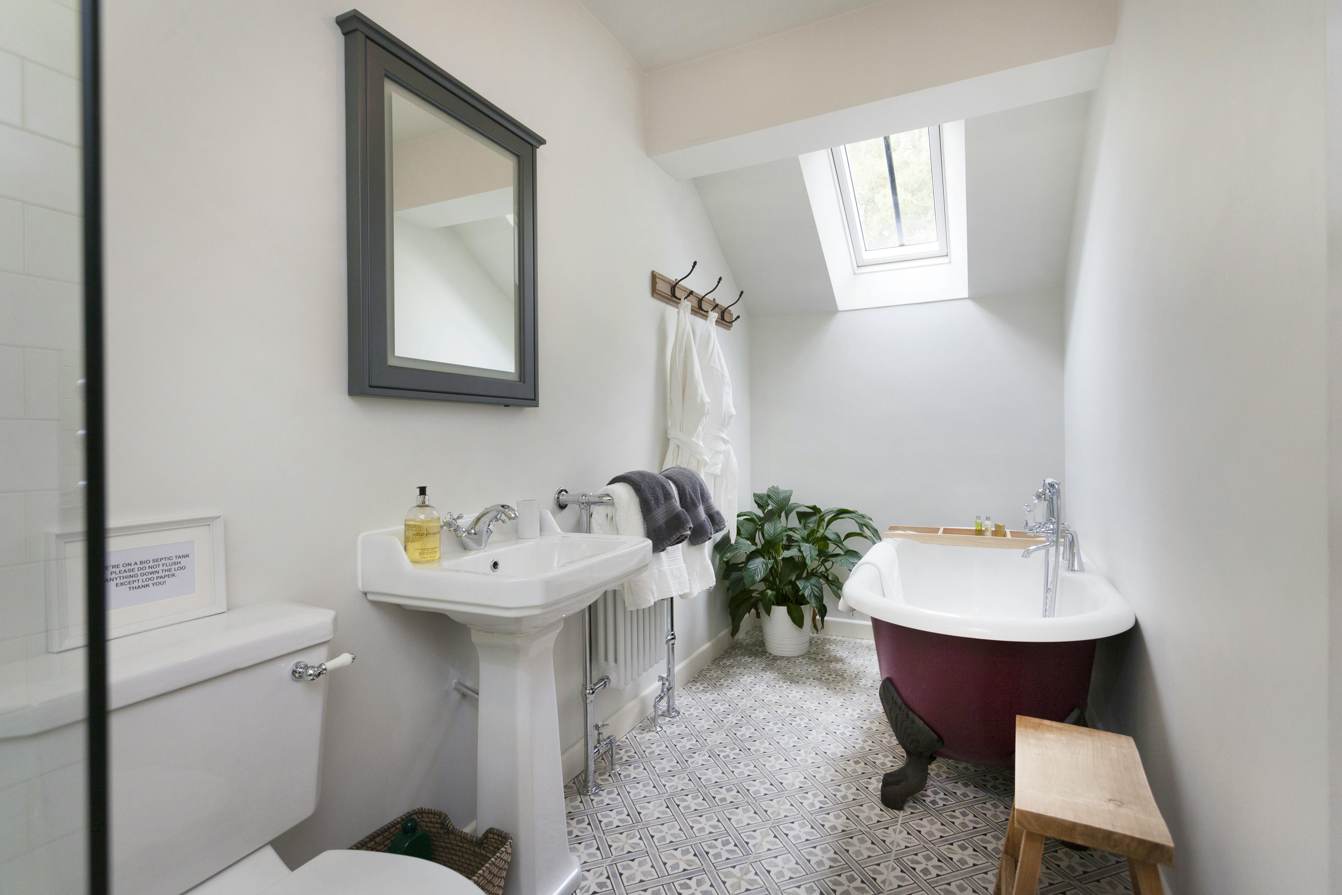 ensuite bathroom with a walk in rain shower and heated towel rail.