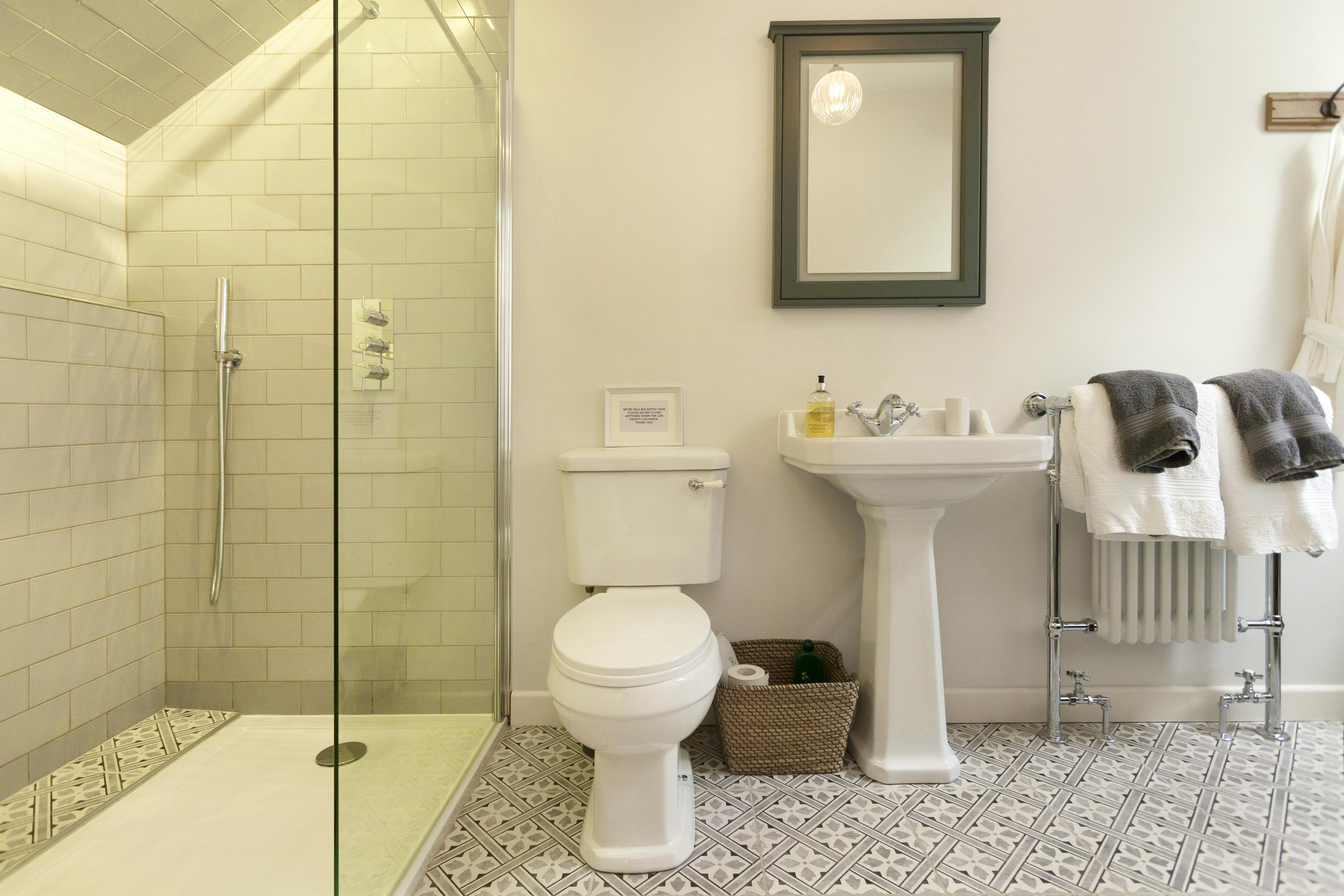 ensuite bathroom with roll top bath and walk in rain shower